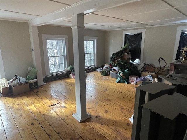 interior space with hardwood / wood-style flooring and ornate columns