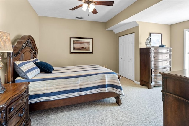 carpeted bedroom with a closet and ceiling fan