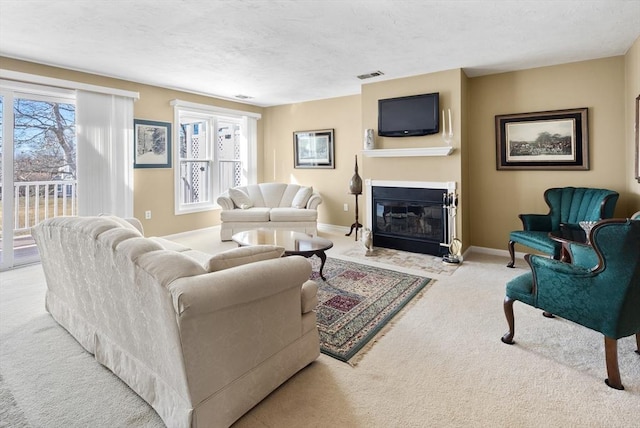 living room featuring light colored carpet and a textured ceiling