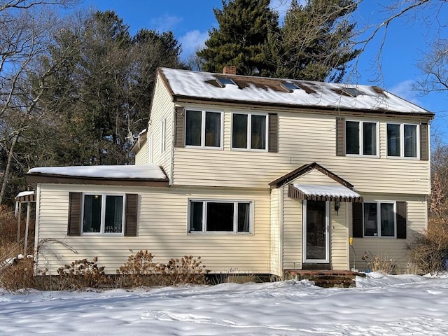 colonial-style house with a chimney