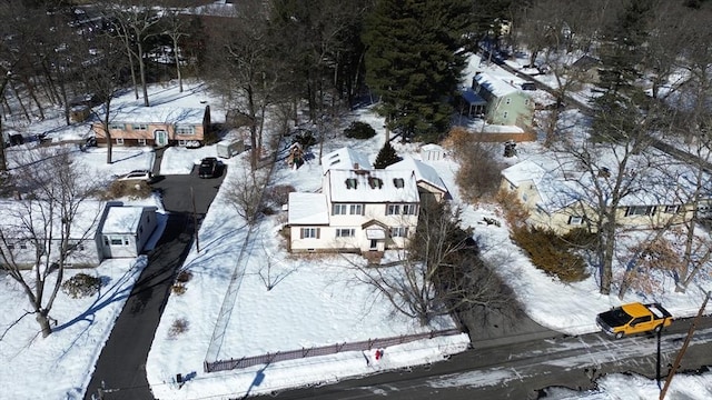 snowy aerial view featuring a residential view