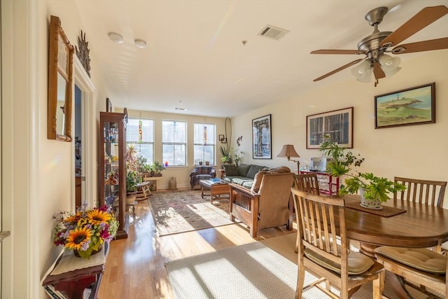 living room featuring ceiling fan and light hardwood / wood-style floors