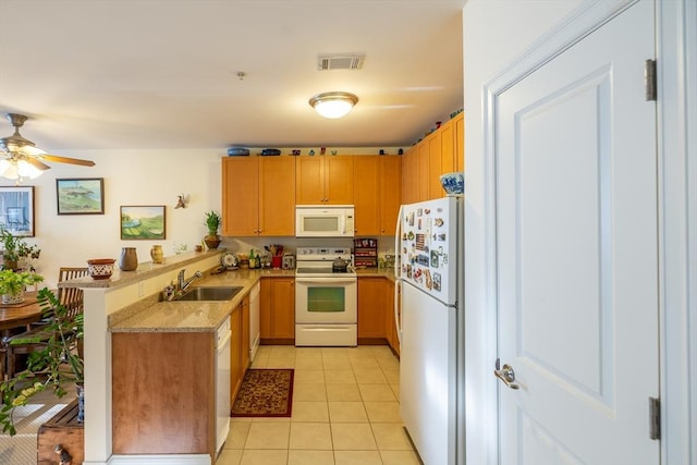 kitchen with ceiling fan, sink, kitchen peninsula, white appliances, and light tile patterned floors