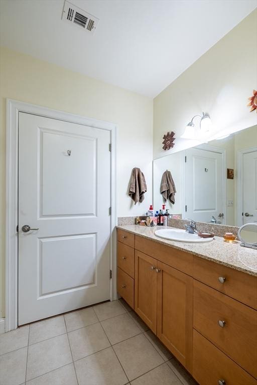 bathroom featuring tile patterned flooring and vanity