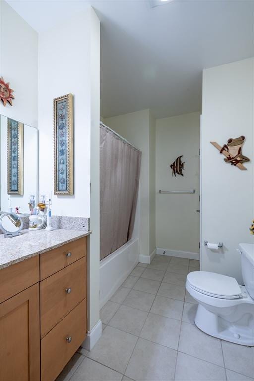 full bathroom featuring tile patterned floors, vanity, toilet, and shower / bath combo with shower curtain