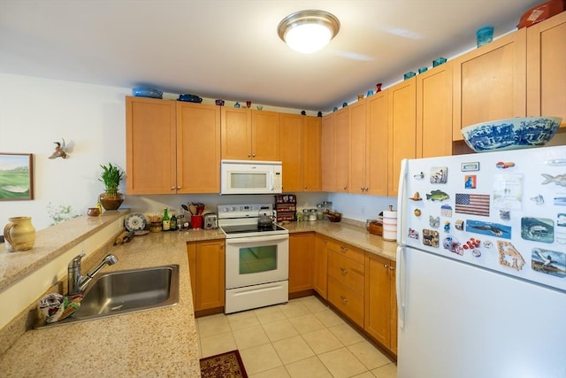 kitchen with light tile patterned floors, white appliances, and sink