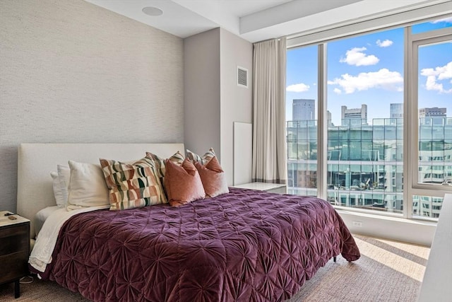 bedroom featuring a city view and visible vents