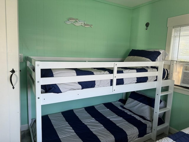 bedroom featuring wooden walls