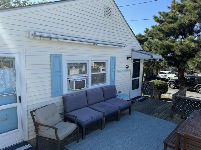 wooden deck featuring cooling unit and an outdoor hangout area