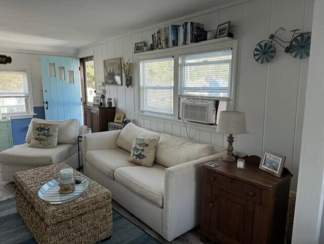 living room with cooling unit and dark wood-type flooring