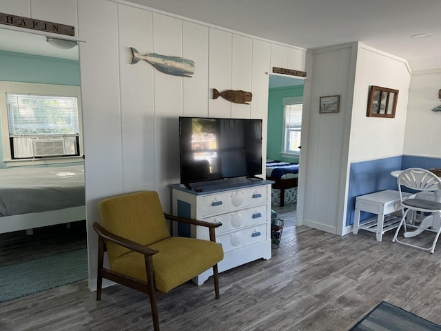 living room with cooling unit and wood-type flooring