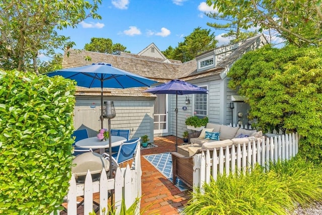 rear view of house with an outdoor living space and a patio