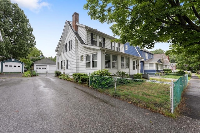 73 Biltmore St, Springfield, MA 01108 - view of front of house with a chimney, a garage, and an outdoor structure
