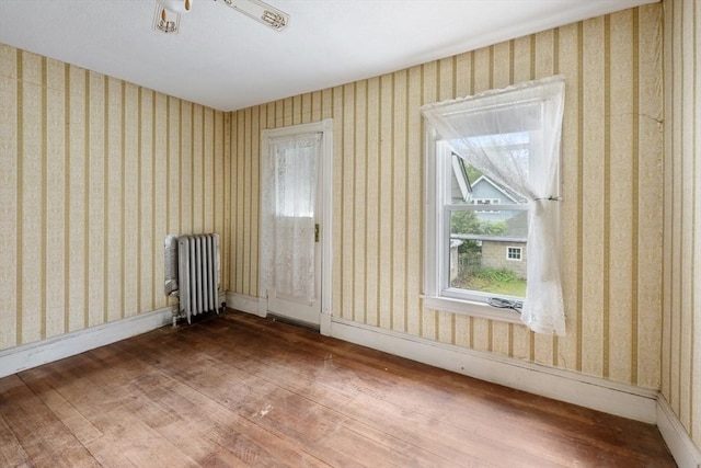 73 Biltmore St, Springfield, MA 01108 - spare room with radiator heating unit, hardwood / wood-style floors, and wallpapered walls