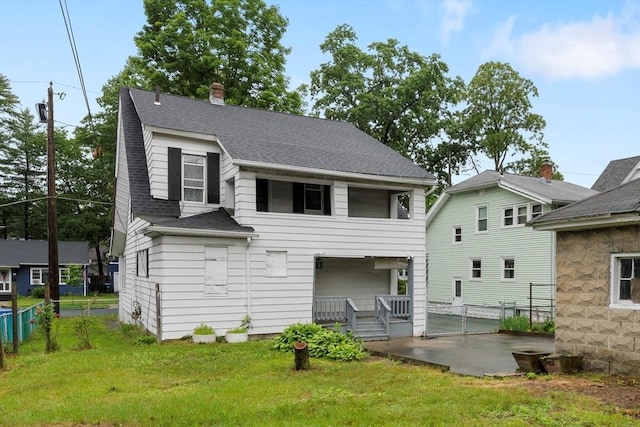 73 Biltmore St, Springfield, MA 01108 - rear view of property featuring roof with shingles and a chimney