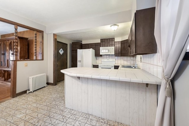 73 Biltmore St, Springfield, MA 01108 - kitchen with radiator heating unit, white appliances, tile counters, and dark brown cabinetry