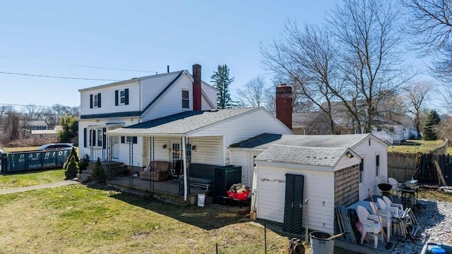 23 Bardsley St, Acushnet, MA 02743 - rear view of house with a shingled roof, a patio, and a chimney