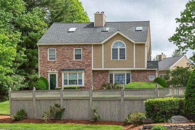 5 Brookfield Dr Unit B, Groton, MA 01450 - back of property with brick siding, a chimney, and roof with shingles