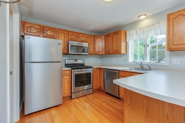 5 Brookfield Dr Unit B, Groton, MA 01450 - kitchen with appliances with stainless steel finishes, light countertops, light wood-style flooring, and brown cabinetry