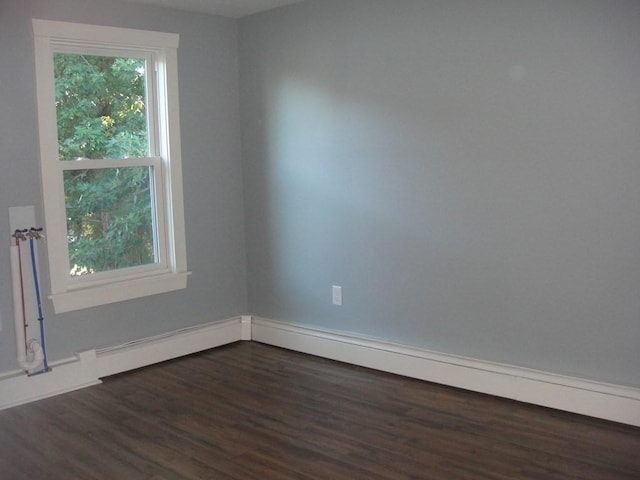 unfurnished room featuring dark wood-style flooring