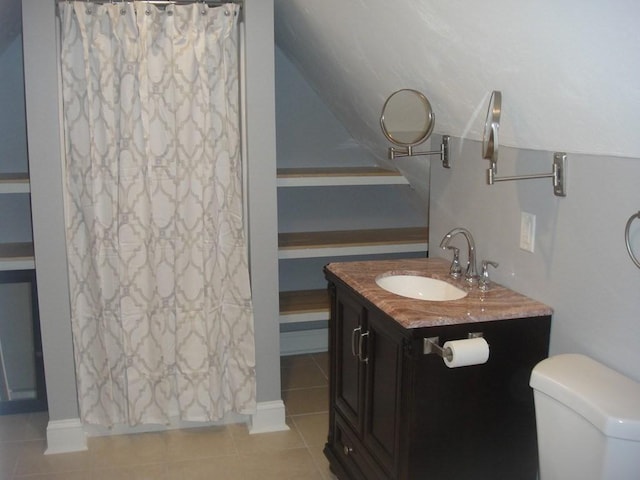 bathroom featuring vanity, tile patterned floors, curtained shower, and toilet