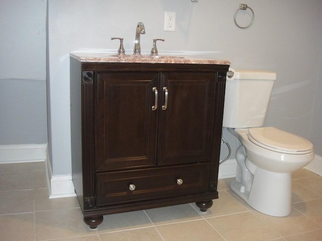 bathroom with vanity, tile patterned floors, and toilet