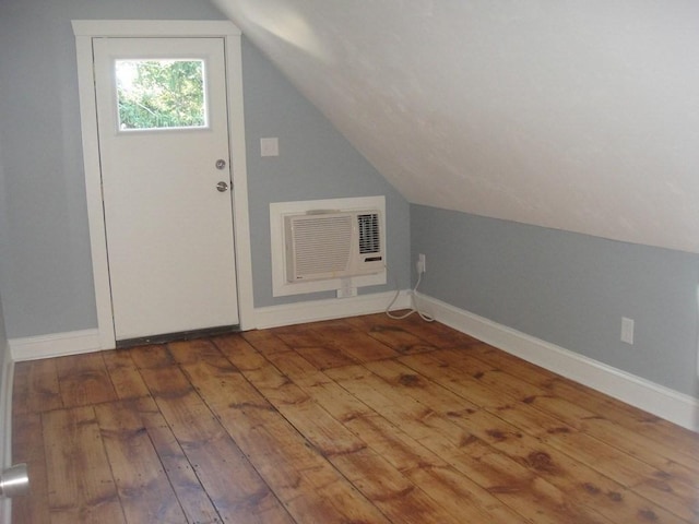 bonus room featuring hardwood / wood-style flooring, baseboards, and vaulted ceiling