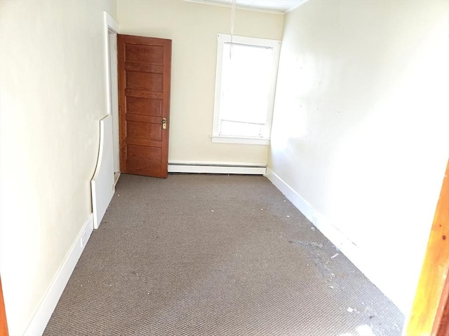 carpeted spare room featuring a baseboard radiator