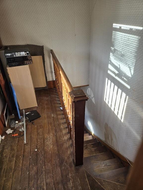 stairway featuring wood-type flooring