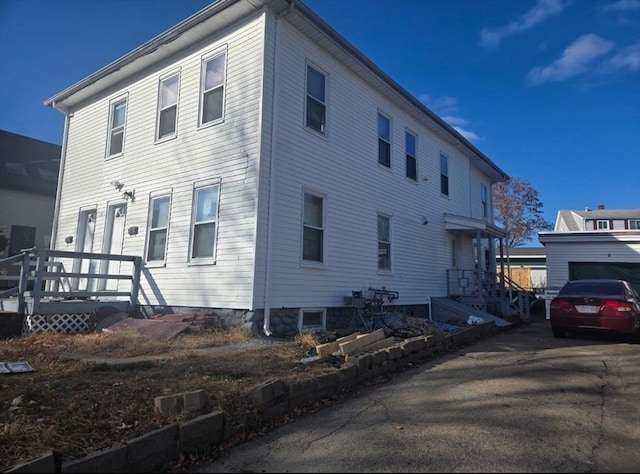 view of side of property featuring a wooden deck