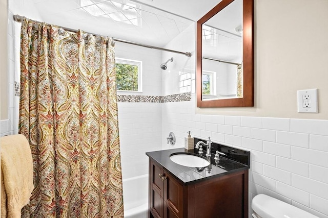 9 Lily Pond Ln, Cohasset, MA 02025 - bathroom with wainscoting, vanity, toilet, shower / bath combination with curtain, and tile walls