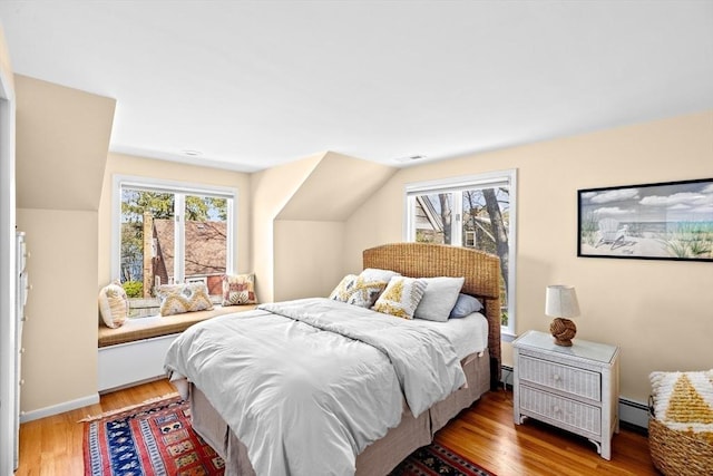 9 Lily Pond Ln, Cohasset, MA 02025 - bedroom featuring baseboards, visible vents, baseboard heating, and light wood-style floors