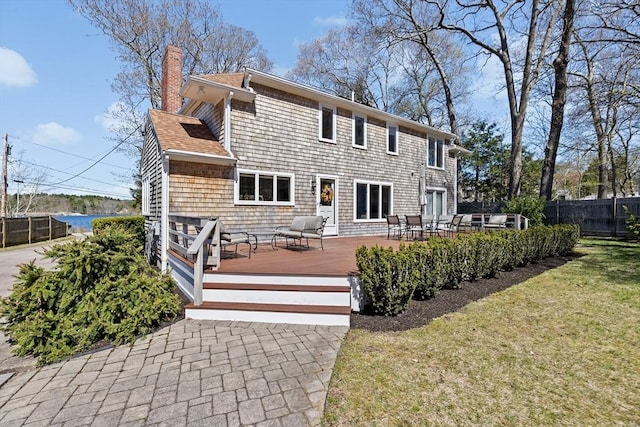 9 Lily Pond Ln, Cohasset, MA 02025 - back of house with a wooden deck, fence, a yard, and a chimney