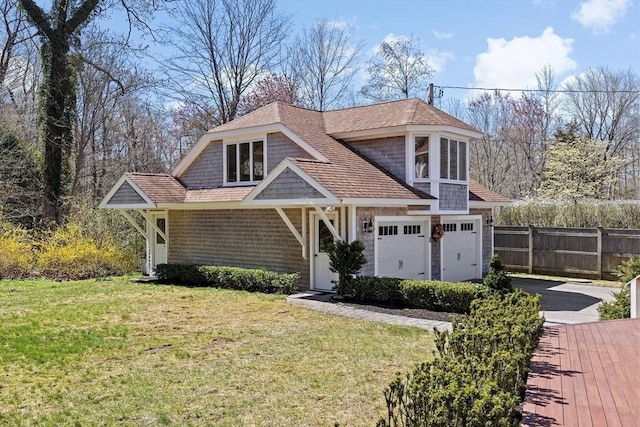 9 Lily Pond Ln, Cohasset, MA 02025 - view of front of home featuring fence, a shingled roof, a garage, a front yard, and driveway
