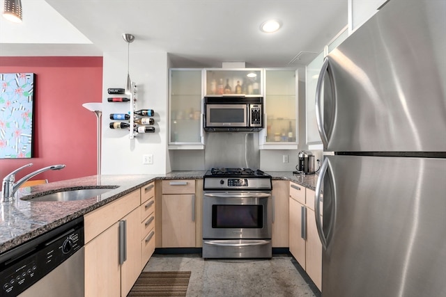 kitchen featuring hanging light fixtures, sink, light brown cabinetry, kitchen peninsula, and stainless steel appliances