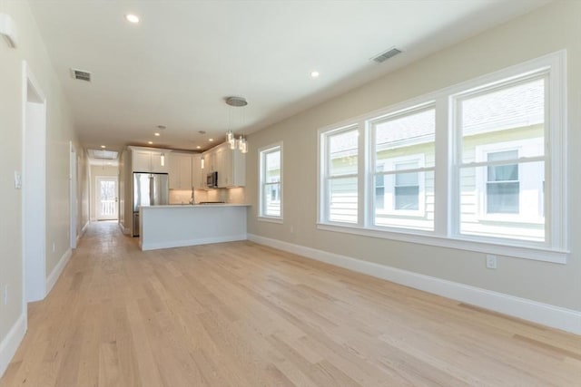 103-105 Neponset Ave, Boston, MA 02131 - unfurnished living room with healthy amount of natural light, light wood-type flooring, and recessed lighting