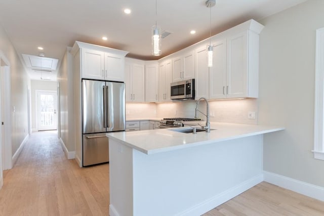 103-105 Neponset Ave, Boston, MA 02131 - kitchen with stainless steel appliances, light wood-type flooring, a peninsula, light countertops, and tasteful backsplash