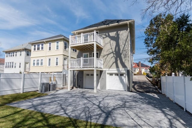 103-105 Neponset Ave, Boston, MA 02131 - rear view of property featuring a balcony, concrete driveway, and a garage