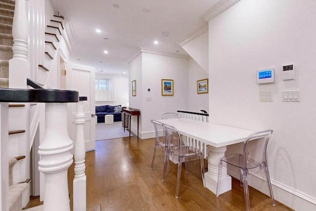 dining room featuring hardwood / wood-style flooring and crown molding