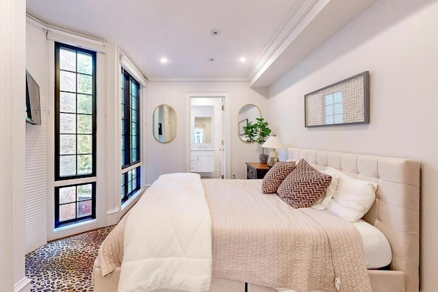 bedroom featuring connected bathroom and crown molding