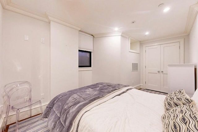 bedroom featuring a closet and crown molding