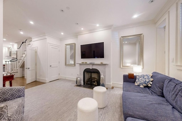 living room with light hardwood / wood-style floors and ornamental molding