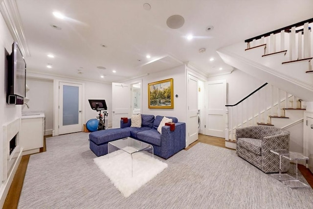 living room with light wood-type flooring and ornamental molding