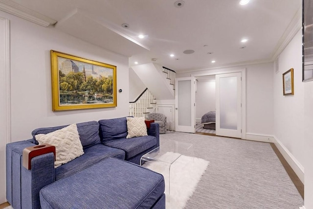 living room with light wood-type flooring and ornamental molding