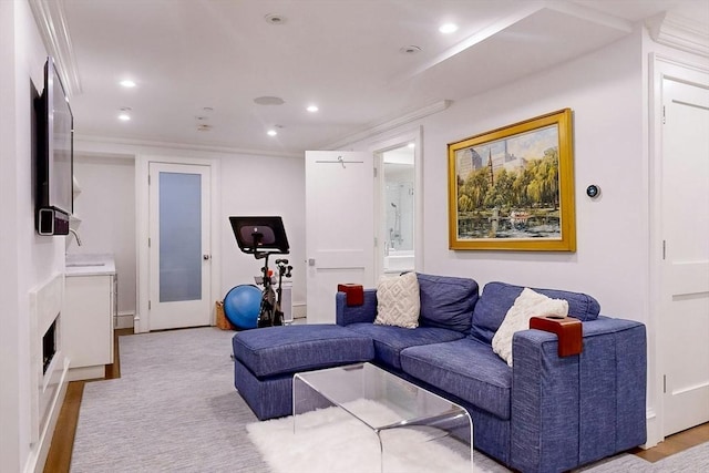 living room with light wood-type flooring and ornamental molding