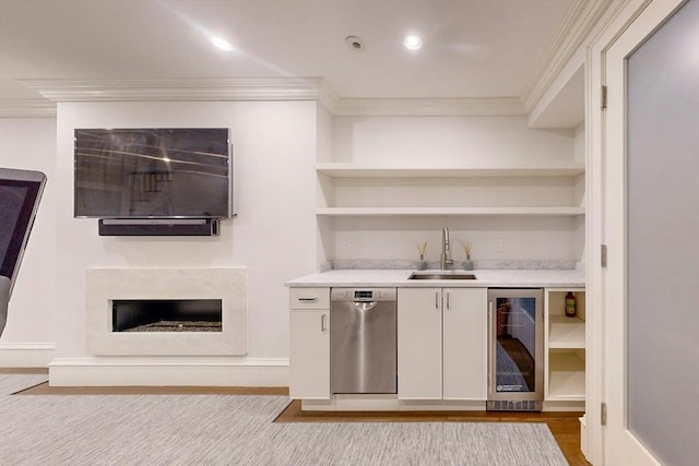 bar featuring stainless steel dishwasher, ornamental molding, sink, white cabinetry, and wine cooler