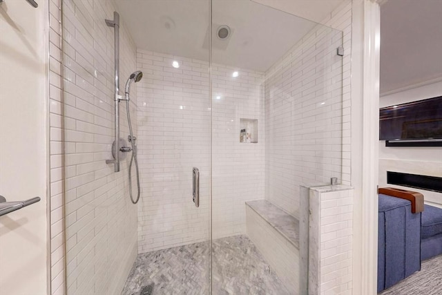 bathroom with a shower with door