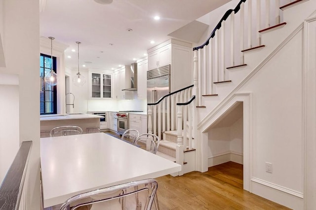 stairs featuring hardwood / wood-style flooring and sink