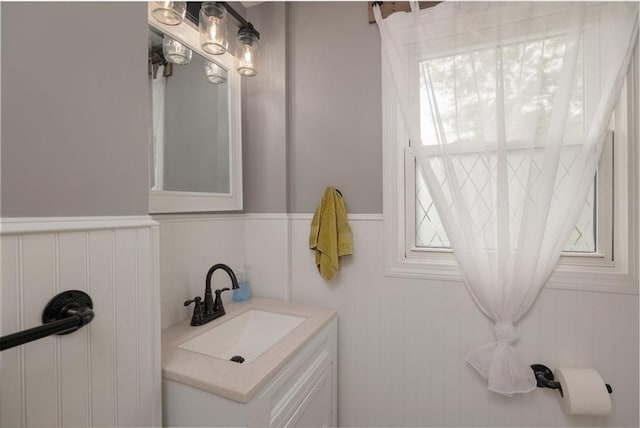 48 Rosemont St Unit 48, Haverhill, MA 01830 - bathroom featuring vanity, healthy amount of natural light, and a wainscoted wall