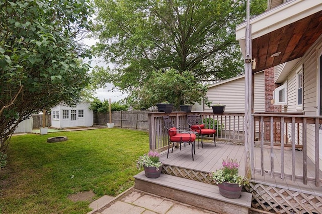 48 Rosemont St Unit 48, Haverhill, MA 01830 - fenced backyard with an outdoor fire pit, a deck, and an outdoor structure